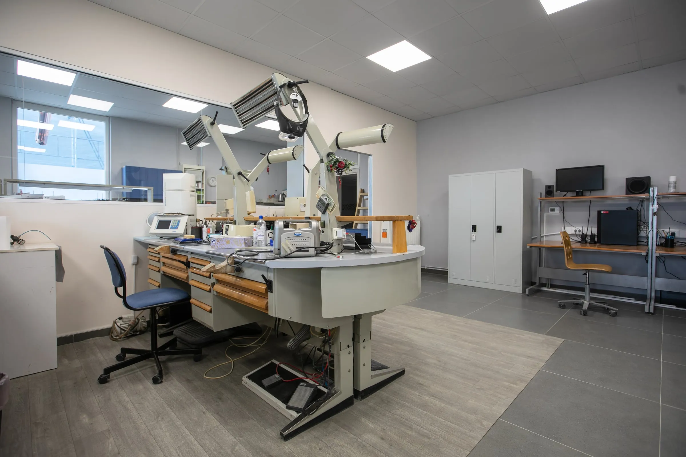 Dental technician bench with task lamps and microscopes